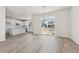 Open concept dining room with hardwood floors and sliding glass doors to patio at 9204 Truckee Ct, Commerce City, CO 80022