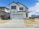 Two-story farmhouse-style home with white siding, gray accents, and a two-car garage at 9204 Truckee Ct, Commerce City, CO 80022