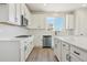 Modern kitchen with white cabinets, quartz countertops and stainless steel appliances at 9204 Truckee Ct, Commerce City, CO 80022