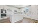 Modern kitchen with white cabinets, quartz countertops, and stainless steel appliances at 9204 Truckee Ct, Commerce City, CO 80022