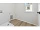 Laundry room with vinyl flooring and a window at 9204 Truckee Ct, Commerce City, CO 80022