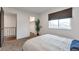 Well-lit bedroom featuring a large window, closet, and comfortable bed at 3355 S Flower St # 95, Lakewood, CO 80227