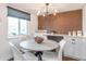 Inviting dining area with modern chandelier, stylish table, and built-in storage at 3355 S Flower St # 95, Lakewood, CO 80227