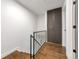 Hallway featuring wood flooring and modern railing at 3355 S Flower St # 95, Lakewood, CO 80227