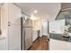 Bright kitchen featuring stainless steel appliances, white cabinets, and hardwood floors at 3355 S Flower St # 95, Lakewood, CO 80227