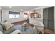 Cozy living room open to kitchen with modern decor, comfortable seating, and hardwood floors at 3355 S Flower St # 95, Lakewood, CO 80227