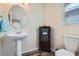 Charming powder room featuring a pedestal sink and decorative accents at 20336 E 48Th Dr, Denver, CO 80249