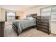 Bedroom featuring a large bed, wood furniture set, and a window with blinds at 20336 E 48Th Dr, Denver, CO 80249