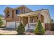 Front exterior featuring a covered front porch and three car garage at 20336 E 48Th Dr, Denver, CO 80249