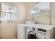 Bright laundry room featuring a washer, dryer and shelving at 20336 E 48Th Dr, Denver, CO 80249