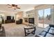 Spacious living room with a cozy fireplace and sliding glass doors to the outside at 20336 E 48Th Dr, Denver, CO 80249