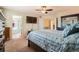 Inviting main bedroom with en-suite bathroom access, featuring a ceiling fan and plush carpeting at 20336 E 48Th Dr, Denver, CO 80249