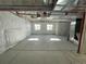 Unfinished basement with concrete floors, white plastic covered walls, and exposed utilities offering potential for customization at 5546 Inland Ave, Firestone, CO 80504