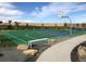 Outdoor basketball court featuring a green surface, bench seating, and beautiful blue sky at 5546 Inland Ave, Firestone, CO 80504