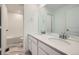 Modern bathroom featuring double sinks, white cabinetry, and a tub-shower with stylish tile at 5546 Inland Ave, Firestone, CO 80504