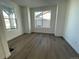 Bright and airy bedroom featuring wood floors, white walls, and large windows offering plenty of natural light at 5546 Inland Ave, Firestone, CO 80504