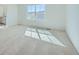 Bright bedroom featuring soft carpeting and a large window at 5546 Inland Ave, Firestone, CO 80504