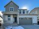 Charming two-story home with a two-car garage, stylish gray and white color scheme, and inviting front porch at 5546 Inland Ave, Firestone, CO 80504