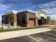 Modern building with a combination of wood, stone, and metal siding with professional landscaping at 5546 Inland Ave, Firestone, CO 80504