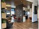 Stylish lounge area featuring modern seating, wood floors, a statement tile wall, and a decorative chandelier at 5546 Inland Ave, Firestone, CO 80504