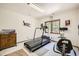 Bright exercise room featuring a treadmill and stationary bike next to large windows overlooking trees at 18150 Martingale Rd, Monument, CO 80132