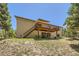 Exterior view of the home featuring a spacious deck with stairs leading to a covered patio at 18150 Martingale Rd, Monument, CO 80132