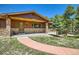 Charming home featuring a stone-clad facade and a welcoming front porch at 18150 Martingale Rd, Monument, CO 80132