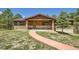 Charming home featuring a stone-clad facade and a welcoming front porch at 18150 Martingale Rd, Monument, CO 80132