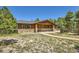 Charming home featuring a stone-clad facade and a welcoming front porch at 18150 Martingale Rd, Monument, CO 80132