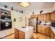 Functional kitchen with oak cabinets, stainless steel appliances, and an island at 18150 Martingale Rd, Monument, CO 80132