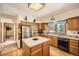 Well-lit kitchen featuring wood cabinets, an island, and plenty of storage space at 18150 Martingale Rd, Monument, CO 80132