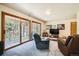 Comfortable living room with a sofa, recliner, and sliding glass doors leading to outdoor patio at 18150 Martingale Rd, Monument, CO 80132