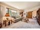 Bright living room featuring a large window, comfortable sofa, and stylish decor at 18150 Martingale Rd, Monument, CO 80132