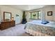 Comfortable main bedroom with a large window and neutral colored carpet and walls at 18150 Martingale Rd, Monument, CO 80132