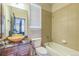 Tiled bathroom with granite countertop and a unique glass vessel sink, offering both tub and shower at 14223 Piney River Rd, Broomfield, CO 80023