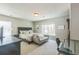 Bedroom with plush carpet, grey walls, a sofa, a computer table, and large windows at 14223 Piney River Rd, Broomfield, CO 80023