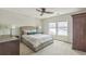 Comfortable bedroom with neutral tones, ceiling fan, two windows, and plush carpet at 14223 Piney River Rd, Broomfield, CO 80023