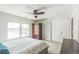 Cozy bedroom with natural light, a ceiling fan, wardrobe, carpeted floors, and white trim at 14223 Piney River Rd, Broomfield, CO 80023