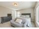 Carpeted bedroom featuring a love seat, dresser, a large window, and a double-door closet at 14223 Piney River Rd, Broomfield, CO 80023