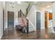 Inviting entryway featuring hardwood floors, a staircase with iron railings, and a decorative vase at 14223 Piney River Rd, Broomfield, CO 80023