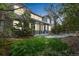 Two-story home with stone and wood exterior, with the backyard and fence visible at 14223 Piney River Rd, Broomfield, CO 80023