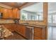 Well-lit kitchen with stone backsplash, stainless steel appliances, hardwood floors, and island seating at 14223 Piney River Rd, Broomfield, CO 80023