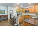 Modern kitchen featuring stainless steel appliances, a central island with seating, and hardwood floors at 14223 Piney River Rd, Broomfield, CO 80023