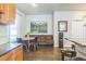 Well-lit kitchen with stone backsplash, stainless steel appliances, hardwood floors, and island seating at 14223 Piney River Rd, Broomfield, CO 80023