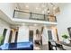 Stylish living area with soaring ceilings, iron railing, contemporary lighting, and an open floor plan at 14223 Piney River Rd, Broomfield, CO 80023