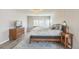Comfortable and spacious main bedroom featuring a patterned rug, dresser, and wooden side table at 14223 Piney River Rd, Broomfield, CO 80023