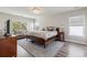 Spacious main bedroom with wood floors, many windows, sitting area, and gorgeous light fixture at 14223 Piney River Rd, Broomfield, CO 80023