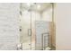 Modern shower with marble-patterned walls, glass door, and sleek fixtures at 14223 Piney River Rd, Broomfield, CO 80023