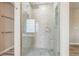 Modern shower with glass door and rain shower head, complemented by stylish tile work at 14223 Piney River Rd, Broomfield, CO 80023