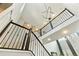 Staircase features iron railings, contemporary lighting, and leads to upper levels of the home at 14223 Piney River Rd, Broomfield, CO 80023